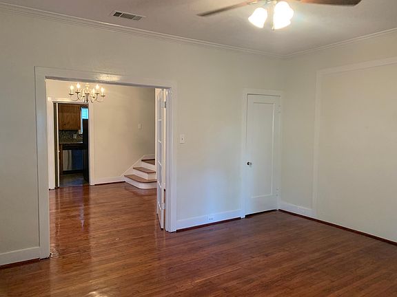 Living room looking into dining room, with under stairs storage closet