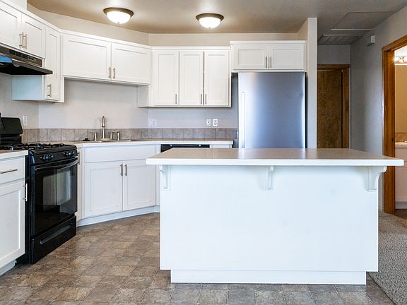 Kitchen looking towards primary bedroom door