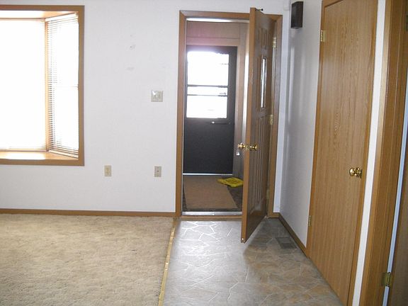 Enclosed front entryway with living room window seat.