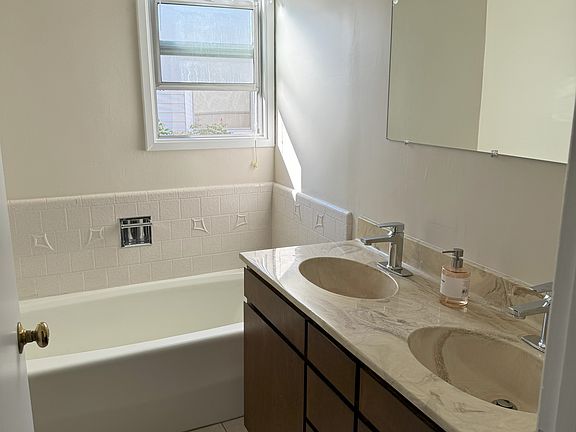 Full bath with tub and stand-alone shower. Dual sinks