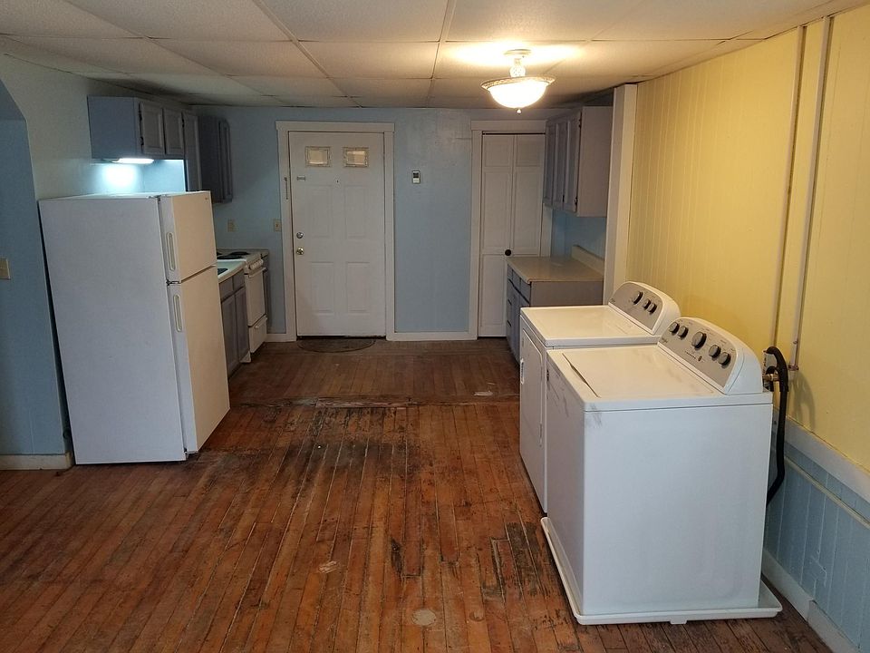 Entrance of apartment looking at kitchen and washer/dryer.