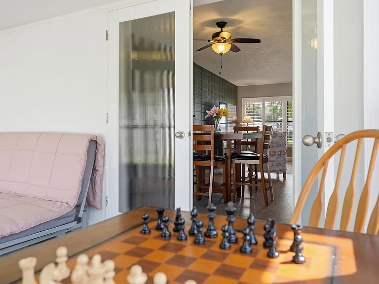 Gaming table view into dining area and living room.