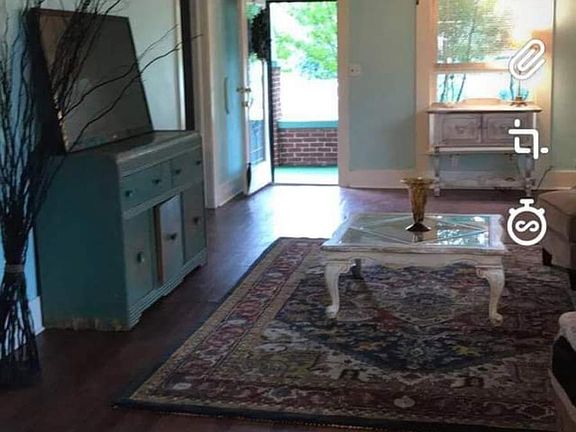 Open living room with ceiling fans at each end.