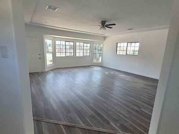 Living room, water proof flooring, recess lighting and ceiling fan. New windows give lots of natural light.