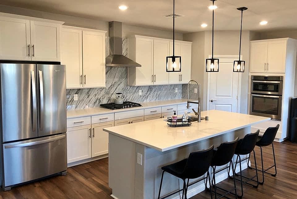 Kitchen. Dimmers on almost every light switch. Marble backsplash, large fridge.