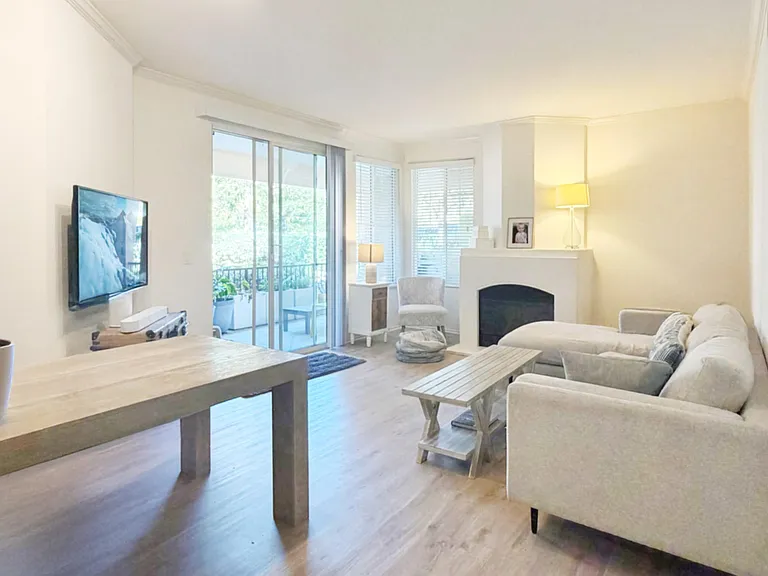 Open living area with comfortable seating, fireplace, and a sliding door to the patio for easy indoor-outdoor flow. Wifi.