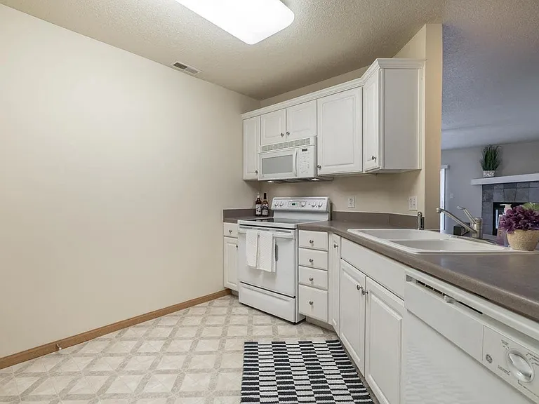 Cook and entertain with ease in your thoughtfully designed kitchen featuring ample cabinetry.
