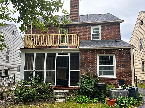Rear with screened porch and balcony above