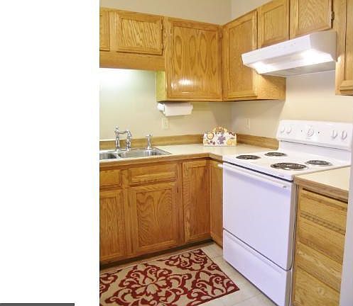 Bright and open kitchen features tile flooring and all new appliances.
