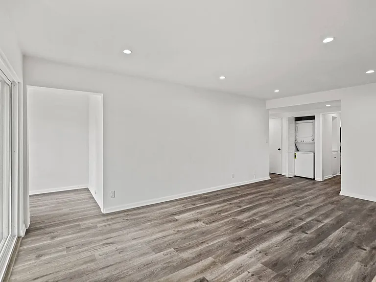 Living Room with Vinyl Flooring, Recessed Lighting. and In-Suite Washer & Dryer
