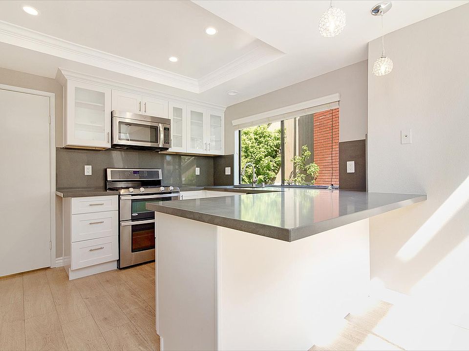 Breakfast bar leads to sunlit nook overlooking private court