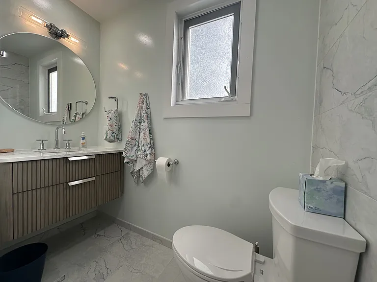 Guest bathroom with lighted mirror.