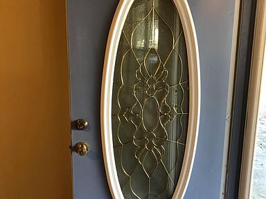 Newly painted front door with glass storm door.