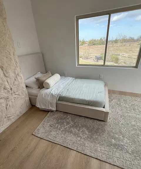 Bedroom with exterior door leading to the chicken coop & Garden.