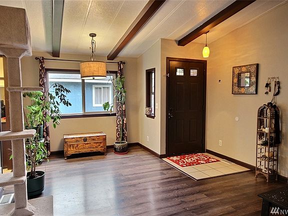 The formal dining room, living room and kitchen offer vaulted ceilings and the entry is tiled.  The dining room and entry light fixtures have been updated.
