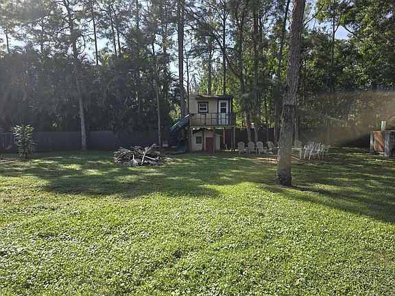 Back of Home with two kids club houses with slide