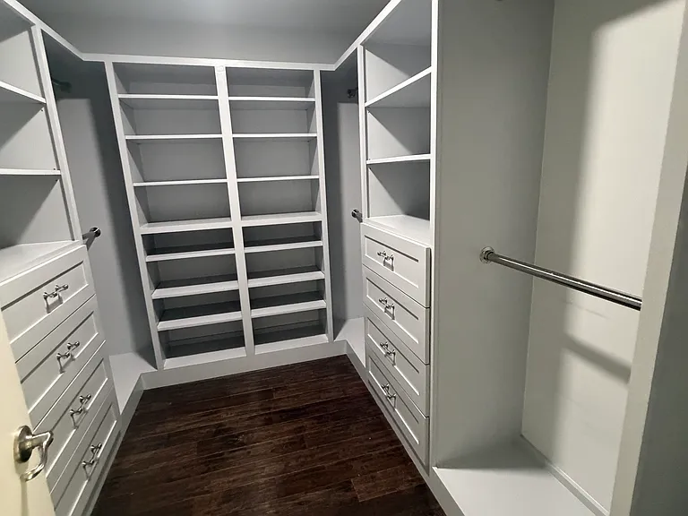 Custom-built walk-in closet in the primary suite, thoughtfully designed with premium built-in organization.