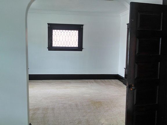 Living room w/ leaded window.