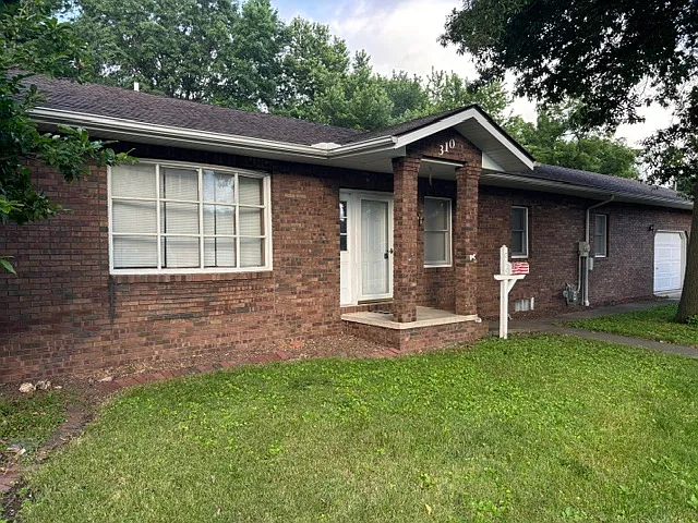 Beautiful brick exterior with concrete walkway and excellent neighbors across the street!