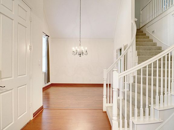Spacious formal dining area with a beautiful lighting fixture.
