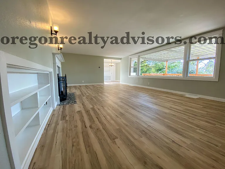 Living Room with built-in shelves looking into Dining Room