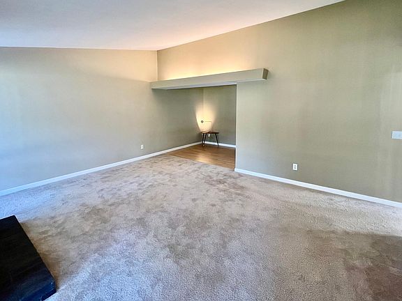 Spacious family room with unique lighting and vaulted ceilings