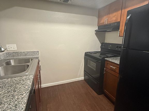 Kitchen, complete with a stove, refrigerator, and dishwasher