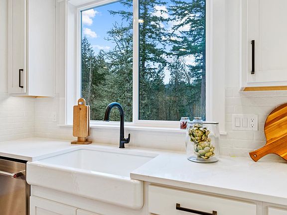 Gourmet Kitchen with Farmhouse Style Sink and Private Greenspace Views