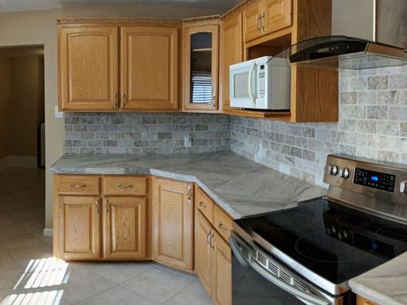 Panoramic kitchen view. All new stainless appliances and travertine