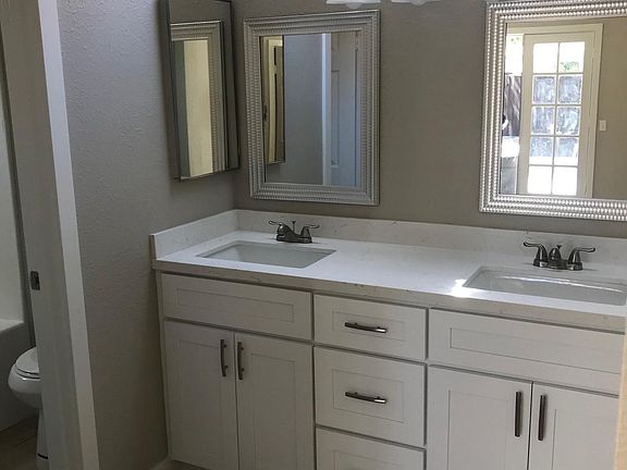 Master bathroom with dual sinks and plenty of cabinet space