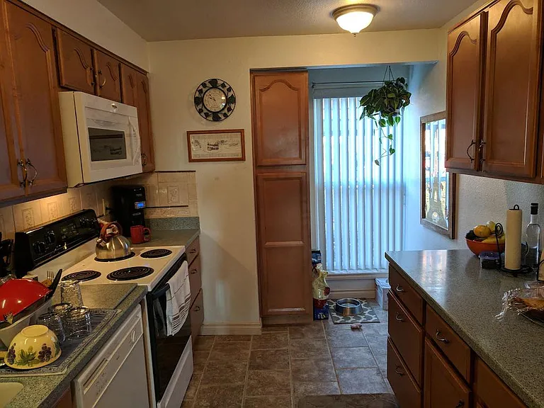 View of back of kitchen from entrance (just past fridge on right and sink on left)