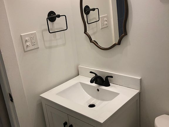 Bath vanity with decorative mirror