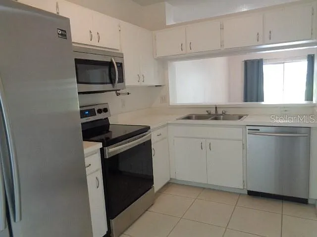 Kitchen has granite countertops and tile backsplash since photos were taken