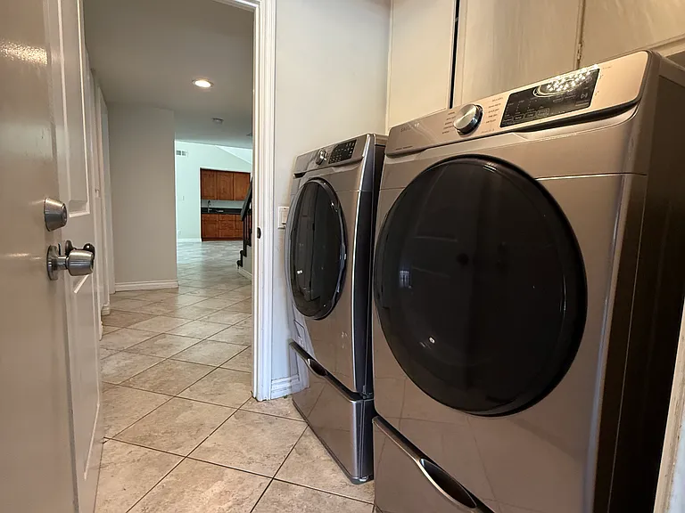 Laundry room with appliances included.