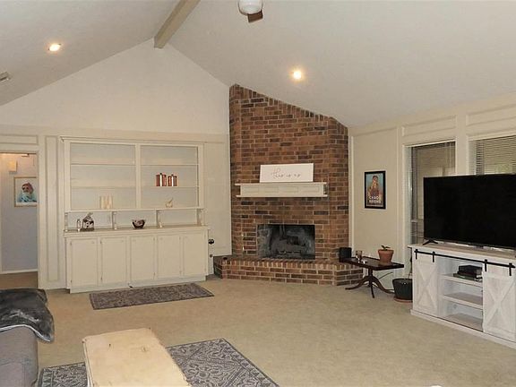 SPACIOUS living room!  Vaulted ceiling, beautiful builtins, and gaslog fireplace!