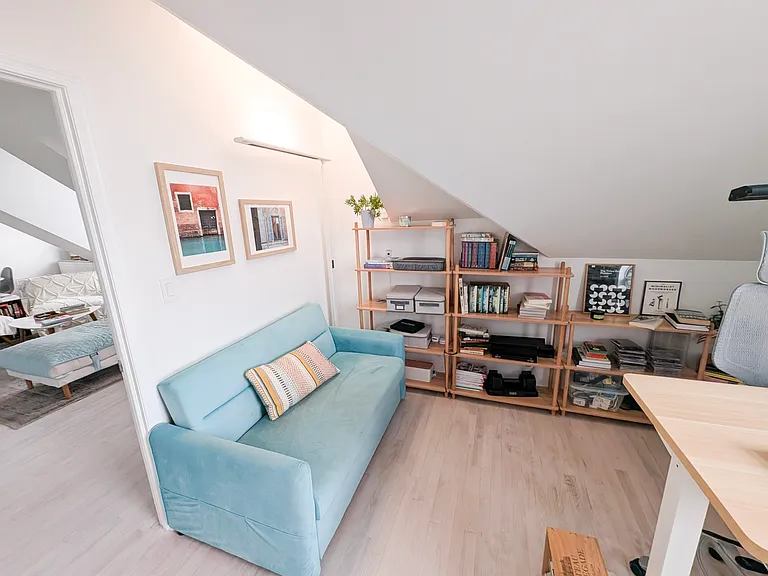Guest bedroom setup as home office with sleeper sofa