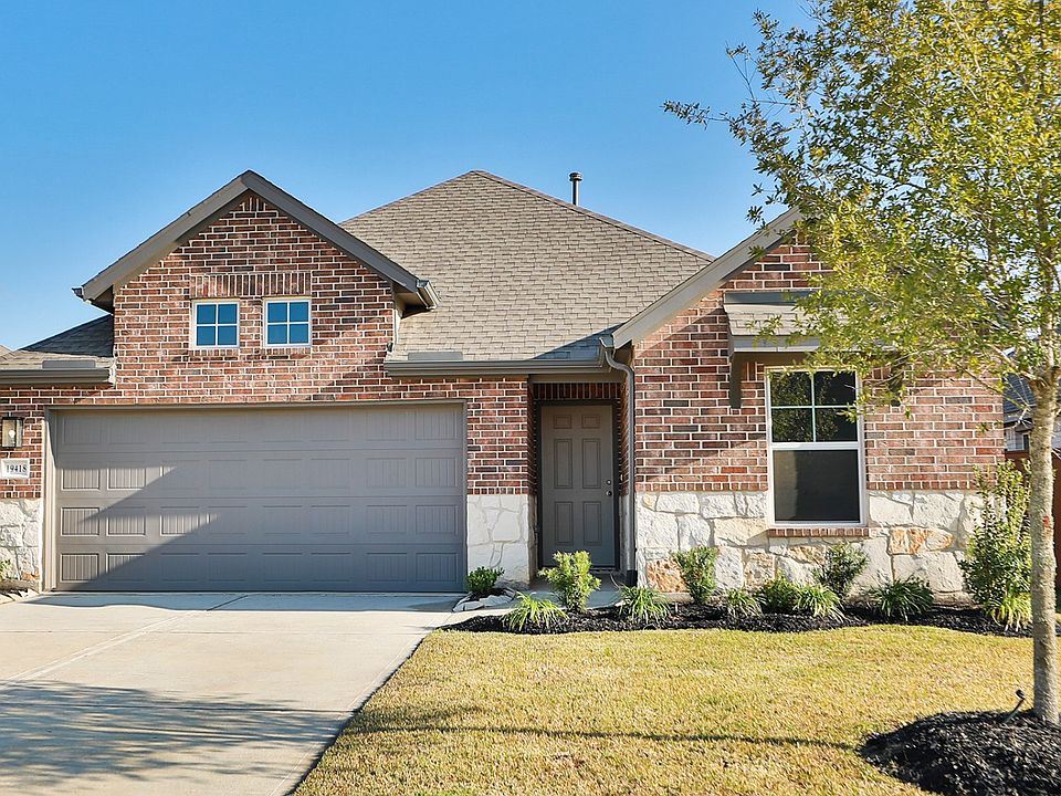 Elegant red brick facade with stylish stone accents exemplifies luxury at Cypress Green.