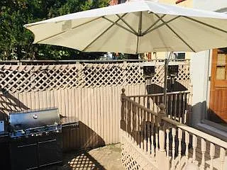 Rear private deck includes oversized umbrella and natural gas fed Webber Summit II grill.
