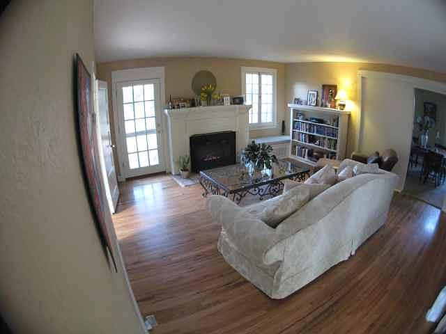 Original wood floors and gas log fireplace give this 1900s house charm.