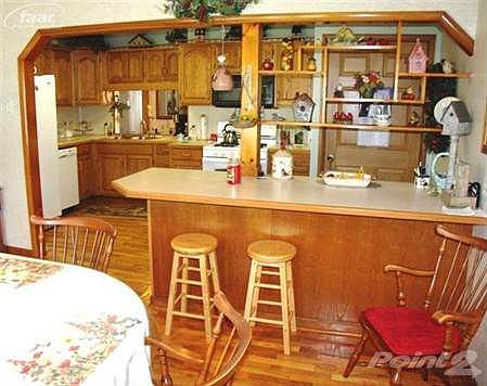 Kitchen includes all appliances with newer refrigerator.