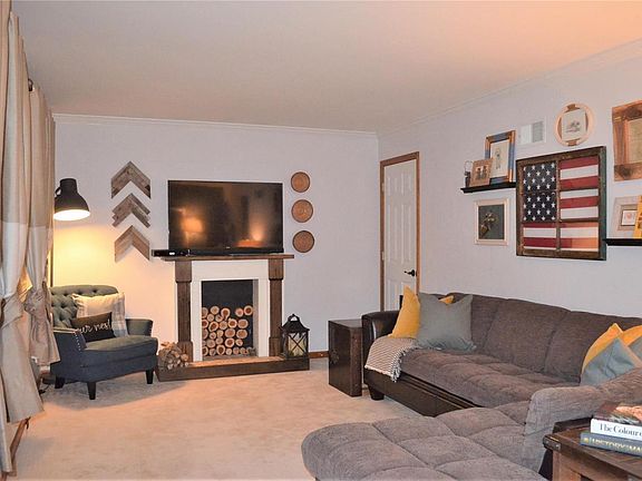 Large living room with cove molding and lots of light from the front windows!