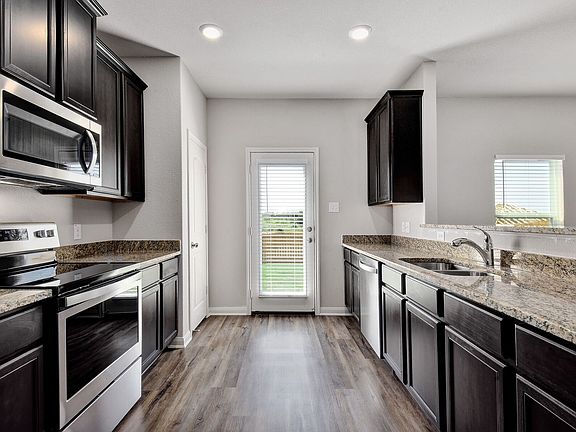 The kitchen has stunning wood cabinetry and great natural lighting.