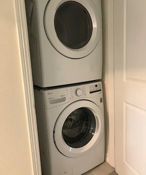 Stacked Washer and Dryer near bedrooms