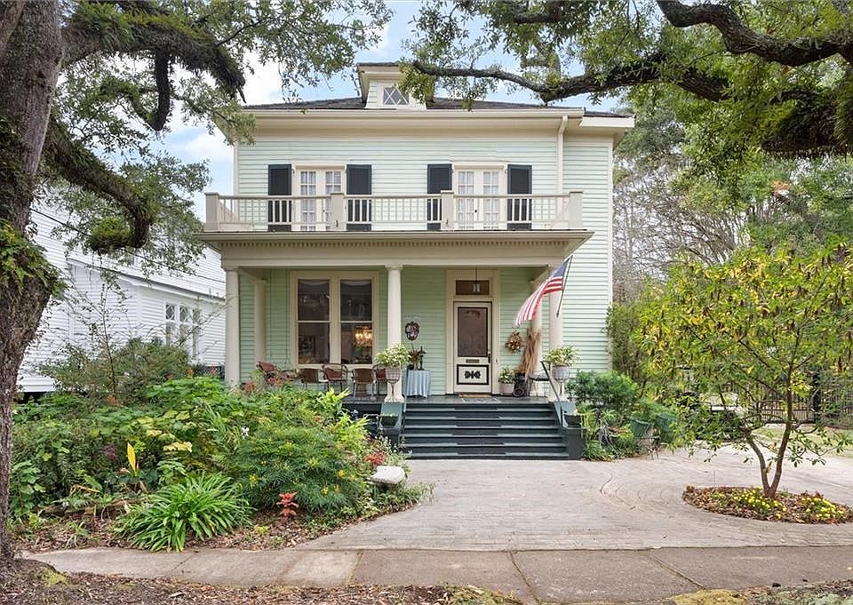 View of front of house with a balcony and a porch