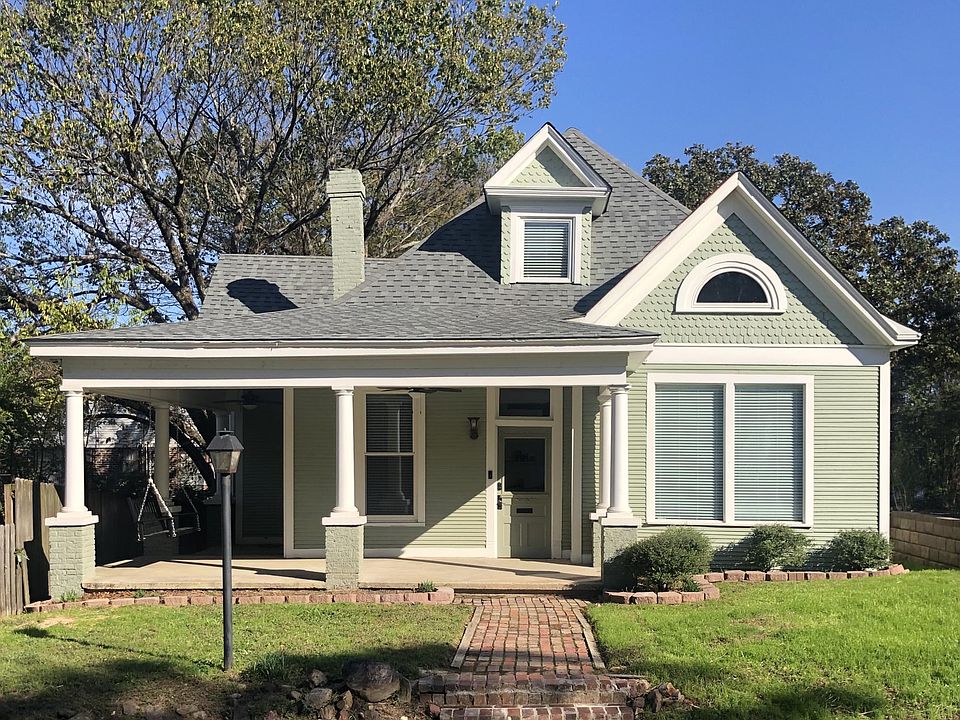 Fantastic curb appeal with antique, brick-lined walkway to covered, wrap-around front porch with swing.