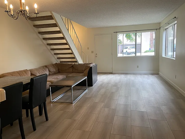 Looking from Kitchen to Dining Room and Living Room to Front Windows and Door