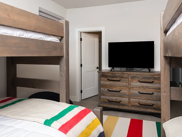 Beautifully crafted, solid wood bunk beds add both style and durability to this inviting mountain retreat.
