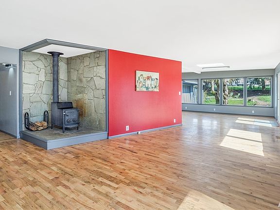 Large living room with a wood stove that can heat the whole house