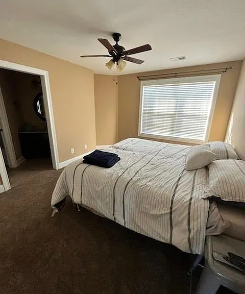 Second upstairs bedroom with shared access to jack and Jill bathroom, includes individual sink and vanity space.