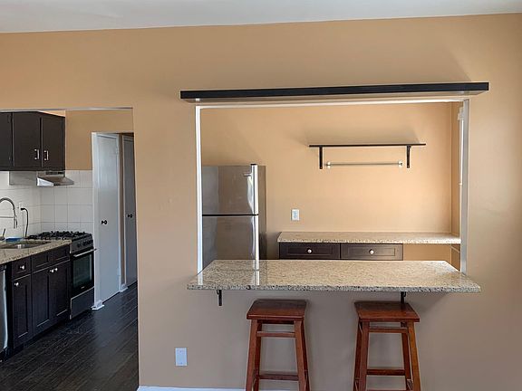 Looking into the kitchen from the living room. granite counter _breakfast bar_